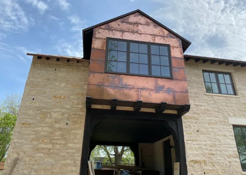 Copper metal panel facade on a stone building for Metal Roof Coating in Rocky Mount