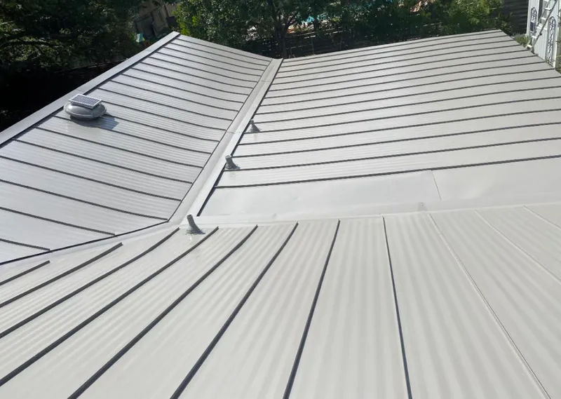 Solar attic fan installed on a metal roof for Roof Ventilation in Rocky Mount